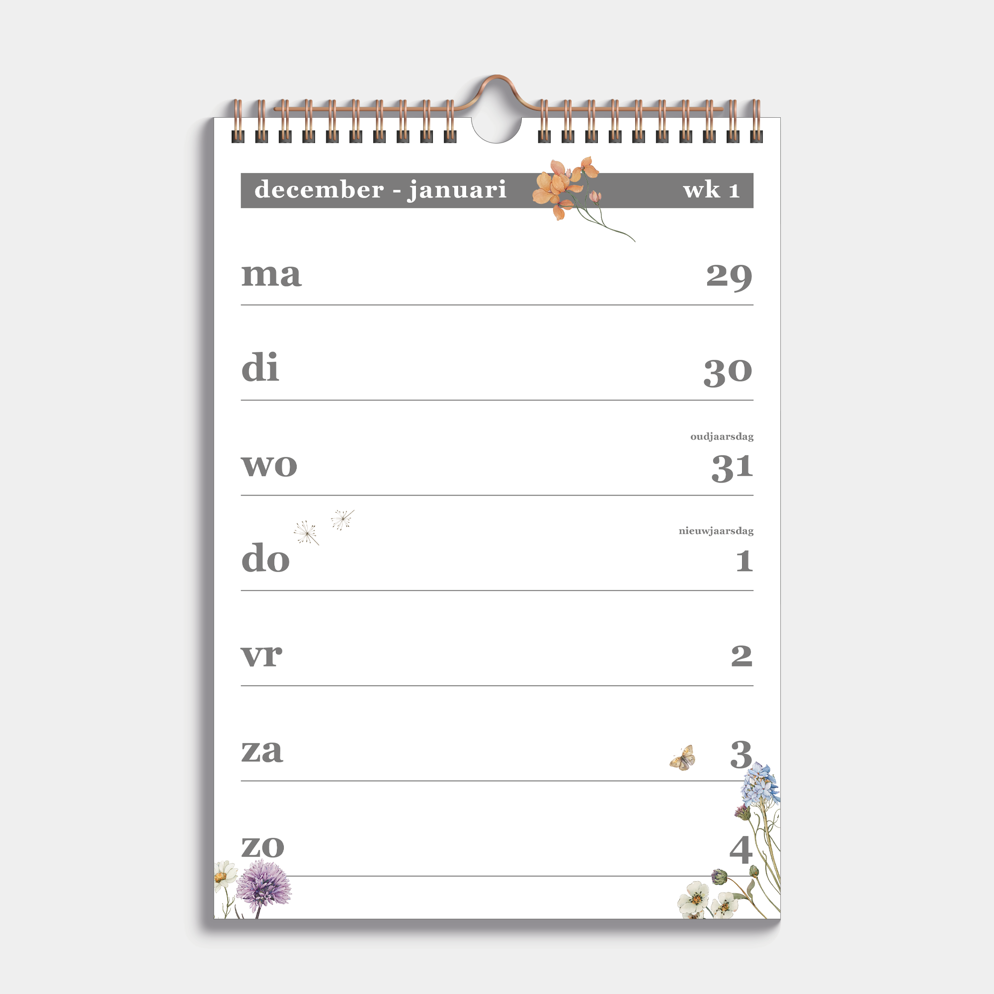 Weekkalender 2026 A4 met een subtiele print van weidebloemen, gebonden in een koperkleurige metalen spiraal en hanger – binnenwerk met weekoverzicht.