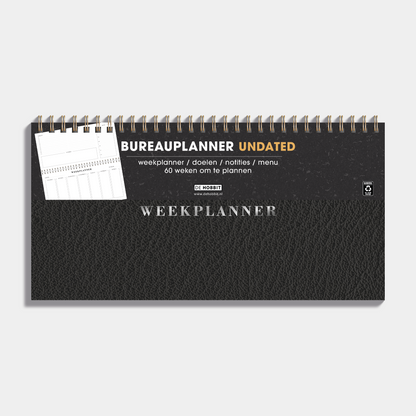 Bureauplanner undated met zwarte lederlook cover en metalen ringband – vooraanzicht met informatieve banderol.