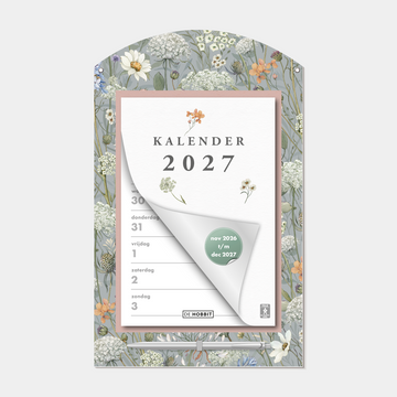 Scheurkalender 2027 op een kartonnen bord voorzien van een print van weidebloemen, met pen – vooraanzicht.